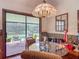 A dining room with a sliding glass door that leads to a screened-in pool at 750 Sw 91St Pl, Ocala, FL 34476