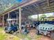 Open barn storage area with golf carts, ATVs and miscellaneous equipment storage, perfect for farm maintenance at 750 Sw 91St Pl, Ocala, FL 34476