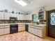 An expansive kitchen with tiled floors, ample counter space, and natural light from a skylight at 750 Sw 91St Pl, Ocala, FL 34476