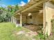 Outdoor storage shed featuring covered area with grassy surroundings and partial wooden walls at 750 Sw 91St Pl, Ocala, FL 34476