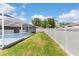 Spacious backyard with a fenced perimeter and screened pool enclosure for privacy and security at 801 Hunt Dr, Lake Wales, FL 33853