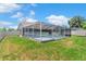 Well-maintained backyard featuring a screened pool enclosure, blending indoor/outdoor living at 801 Hunt Dr, Lake Wales, FL 33853