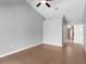 Neutral bedroom featuring wood floors, a ceiling fan, and a door that leads to an ensuite bathroom at 801 Hunt Dr, Lake Wales, FL 33853