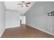 Neutral bedroom with wood floors, a ceiling fan, and a door that leads to an ensuite bathroom at 801 Hunt Dr, Lake Wales, FL 33853
