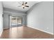 Bright bedroom with wood floors, a ceiling fan, and sliding doors that lead to the screened-in pool area at 801 Hunt Dr, Lake Wales, FL 33853