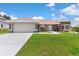 Charming single-story home featuring a well-maintained lawn and a two-car garage at 801 Hunt Dr, Lake Wales, FL 33853