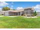 Well-manicured front yard with green grass and decorative landscaping, highlighting the home's curb appeal at 801 Hunt Dr, Lake Wales, FL 33853