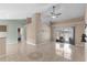 Spacious living room with tile flooring, a ceiling fan, and sliding glass doors to the pool area at 801 Hunt Dr, Lake Wales, FL 33853