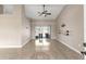 Spacious living room with high ceilings, ceiling fan, and sliding glass doors leading to the outside at 801 Hunt Dr, Lake Wales, FL 33853