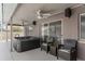 Relaxing covered patio with spa, ceiling fans, and outdoor seating, perfect for entertaining at 801 Hunt Dr, Lake Wales, FL 33853