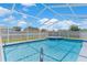 Sparkling in-ground pool under a screened enclosure, ideal for year-round swimming at 801 Hunt Dr, Lake Wales, FL 33853