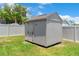 Durable backyard storage shed for tools and equipment, enclosed by a privacy fence at 801 Hunt Dr, Lake Wales, FL 33853