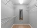 Bright walk-in closet featuring shelving and a full length mirror at 801 Hunt Dr, Lake Wales, FL 33853