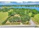 Aerial view of the house surrounded by lush trees and near a serene lake at 802 S 10Th St, Haines City, FL 33844