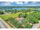 Aerial view showcases the home nestled among lush greenery near a scenic lake at 802 S 10Th St, Haines City, FL 33844