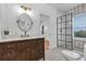 Charming bathroom with wood vanity, quartz countertops, and a stylish glass enclosed shower at 802 S 10Th St, Haines City, FL 33844