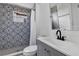 Bathroom features decorative shower tiles, gray vanity, modern fixtures, and ample natural light at 802 S 10Th St, Haines City, FL 33844