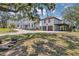 Sprawling estate with a white stucco exterior, red tile roof, and lush greenery, showcasing curb appeal at 802 S 10Th St, Haines City, FL 33844
