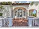 Grand entrance to this stucco home with a red tile porch, and arched entryway and manicured landscaping at 802 S 10Th St, Haines City, FL 33844
