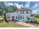 Exterior view of stucco home with red tile roof, arched entryways, and a well manicured yard at 802 S 10Th St, Haines City, FL 33844