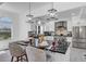 Modern kitchen featuring sleek white cabinets, stainless steel appliances, and a large island with seating at 802 S 10Th St, Haines City, FL 33844