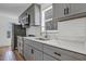 Modern kitchen features gray cabinets, white countertops, stainless steel appliances, and subway tile backsplash at 802 S 10Th St, Haines City, FL 33844