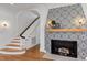 Inviting living room with patterned fireplace, wood floors, and staircase leading upstairs at 802 S 10Th St, Haines City, FL 33844