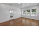 Bright room featuring hardwood floors, white trim, and an abundance of natural light from large windows at 802 S 10Th St, Haines City, FL 33844