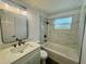 Modern bathroom with a new vanity, stylish fixtures, tub, and marble-look tile at 804 Starke Lake Cir, Ocoee, FL 34761