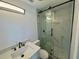 Modern bathroom featuring a sleek glass shower with patterned tiles and a stylish sink with black hardware at 804 Starke Lake Cir, Ocoee, FL 34761
