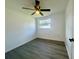 This bedroom features sleek modern flooring, a ceiling fan, and a bright window at 804 Starke Lake Cir, Ocoee, FL 34761