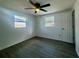 Bright bedroom featuring updated flooring, a ceiling fan, and two windows providing natural light at 804 Starke Lake Cir, Ocoee, FL 34761