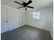Bright bedroom with modern flooring, a ceiling fan, a window, and closet for ample storage at 804 Starke Lake Cir, Ocoee, FL 34761