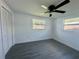 Bright, spacious bedroom with updated flooring, a ceiling fan, two windows, and closet at 804 Starke Lake Cir, Ocoee, FL 34761