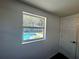 A bedroom window overlooks a beautiful pool, offering a serene view and natural light at 804 Starke Lake Cir, Ocoee, FL 34761