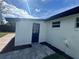 Exterior of a house with a dark blue door, a window, and a paved walkway at 804 Starke Lake Cir, Ocoee, FL 34761