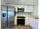 Updated kitchen with stainless steel appliances, modern countertops, and stylish backsplash at 804 Starke Lake Cir, Ocoee, FL 34761