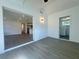 Spacious living room with views to the kitchen and laundry space, featuring modern vinyl flooring at 804 Starke Lake Cir, Ocoee, FL 34761