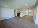 Open-concept living room flows into a modern kitchen, featuring sleek flooring and natural light at 804 Starke Lake Cir, Ocoee, FL 34761
