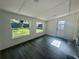Sunlit living room features sleek flooring, multiple windows, and an exterior door at 804 Starke Lake Cir, Ocoee, FL 34761