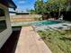 Backyard featuring a sparkling in-ground pool surrounded by a concrete patio and lush landscaping at 804 Starke Lake Cir, Ocoee, FL 34761