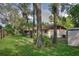The backyard features a well-manicured lawn and beautiful shade trees at 916 Great Bend Rd, Altamonte Springs, FL 32714