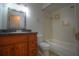 Bathroom featuring dark vanity, toilet, and bathtub with white tile surround at 916 Great Bend Rd, Altamonte Springs, FL 32714