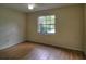 Bedroom featuring laminate wood floors and a large window for natural light at 916 Great Bend Rd, Altamonte Springs, FL 32714
