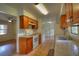 Traditional kitchen featuring tile floors, wooden cabinetry, and white appliances at 916 Great Bend Rd, Altamonte Springs, FL 32714