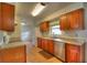 Traditional kitchen featuring stainless steel appliances, tile flooring, and wooden cabinetry at 916 Great Bend Rd, Altamonte Springs, FL 32714