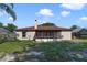 Exterior view of backyard with screened patio and well maintained lawn at 925 S Dean Cir, Deltona, FL 32738