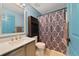Well lit bathroom with a single sink vanity, matching hardware, and shower-tub combination at 925 S Dean Cir, Deltona, FL 32738