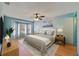 This cozy main bedroom features a ceiling fan, wood floors, and a window nook for lots of light at 925 S Dean Cir, Deltona, FL 32738