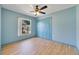 Cozy bedroom with a closet, light-colored wood flooring, and a window at 925 S Dean Cir, Deltona, FL 32738